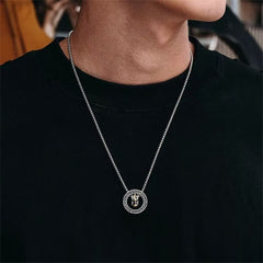 Double Ring PiXiu Necklace – Man wearing silver circular pendant with golden PiXiu on chain over black t-shirt
