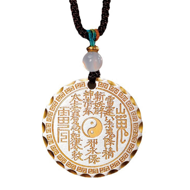 Mountain Ghosts Spend Money Yin Yang Bagua De - Full Taoist amulet necklace on white bg, gold yin-yang pendant, black cord