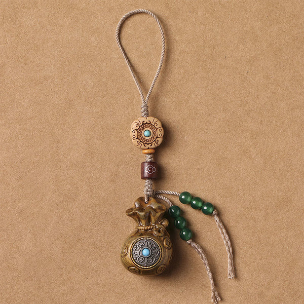 Sandalwood Om Mani Padme Hum Key Chain – light wood with green beads tassel, calming serene