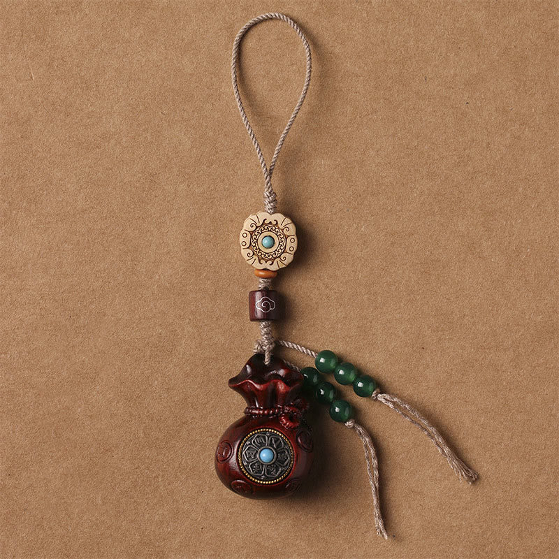 Sandalwood Om Mani Padme Hum Key Chain – dark wood with green bead tassel, serenity protection