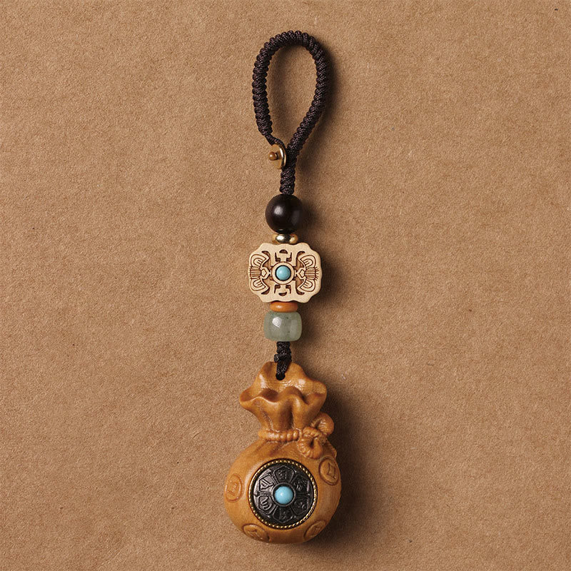 Sandalwood Om Mani Padme Hum Key Chain – natural tan wood pendant with cord, grounding calm