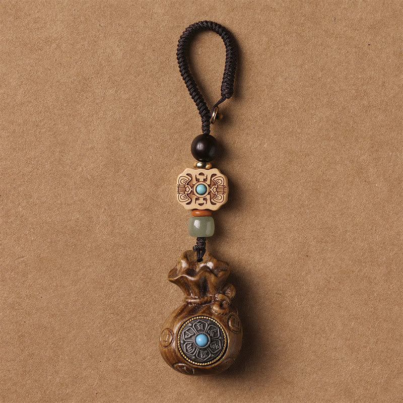 Sandalwood Om Mani Padme Hum Key Chain – light wood pendant with dark cord, peaceful mindful