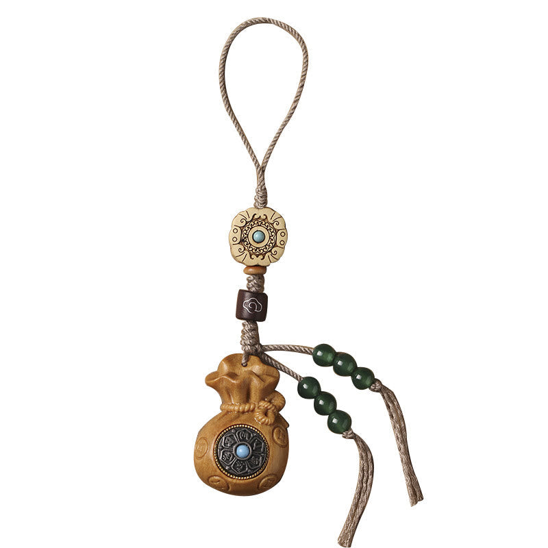 Sandalwood Om Mani Padme Hum Key Chain – light tan wood charm isolated, clean minimalist