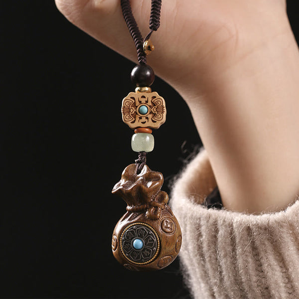 Sandalwood Om Mani Padme Hum Key Chain – closeup of carved wood charm, tranquil grounding