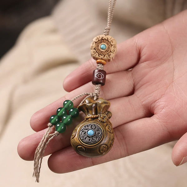 Sandalwood Om Mani Padme Hum Key Chain – hand holding beaded wood charm, mindful peace