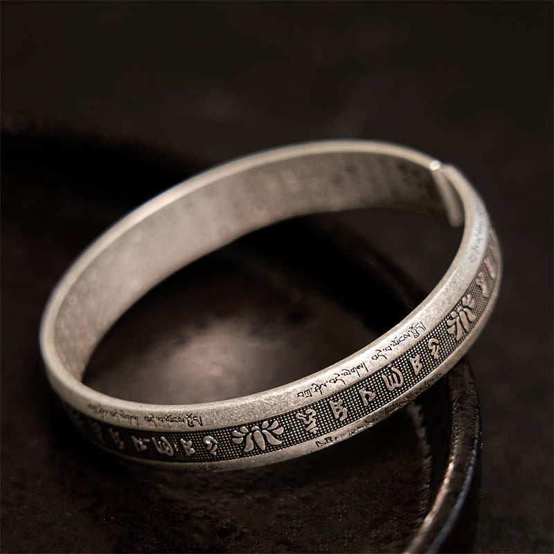 Antique Silver Mantra Cuff – Close-up of raised Tibetan syllables and lotus reliefs on stippled silver band