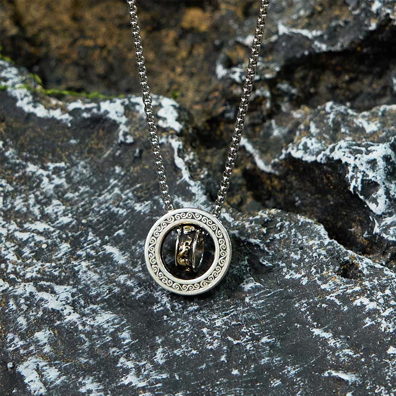 Double Ring PiXiu Necklace – Silver peace buckle pendant with golden PiXiu on textured black rock surface