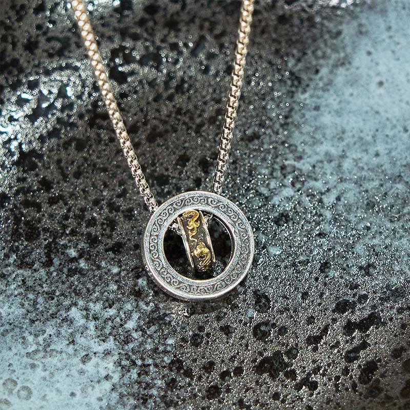 Double Ring PiXiu Necklace – Silver pendant with golden PiXiu on wet dark stone with water droplets, moody lighting