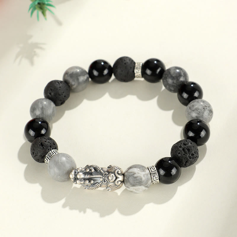 999 Silver PiXiu Bracelet – Top view of silver PiXiu bracelet with green plant shadow on white background
