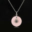 Tree of Life Crystal Necklace – rose quartz donut pendant on black background, frontal silver chain view