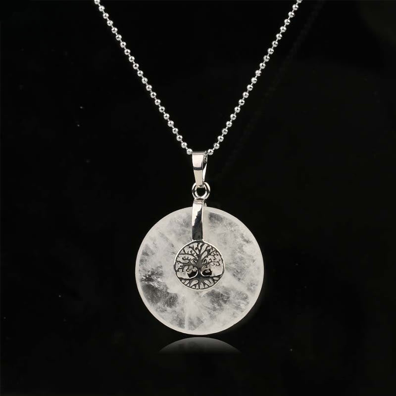 Tree of Life Crystal Necklace – clear quartz donut pendant on black background, frontal silver chain view