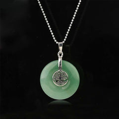 Tree of Life Crystal Necklace – green aventurine donut pendant on black, frontal silver chain view