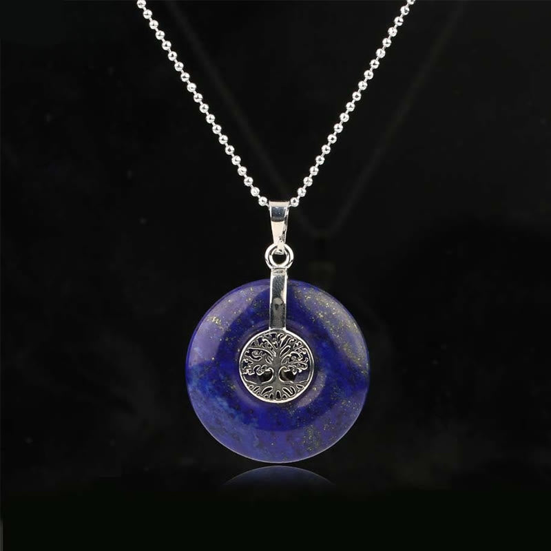 Tree of Life Crystal Necklace – lapis lazuli deep blue donut pendant on black, frontal silver chain view