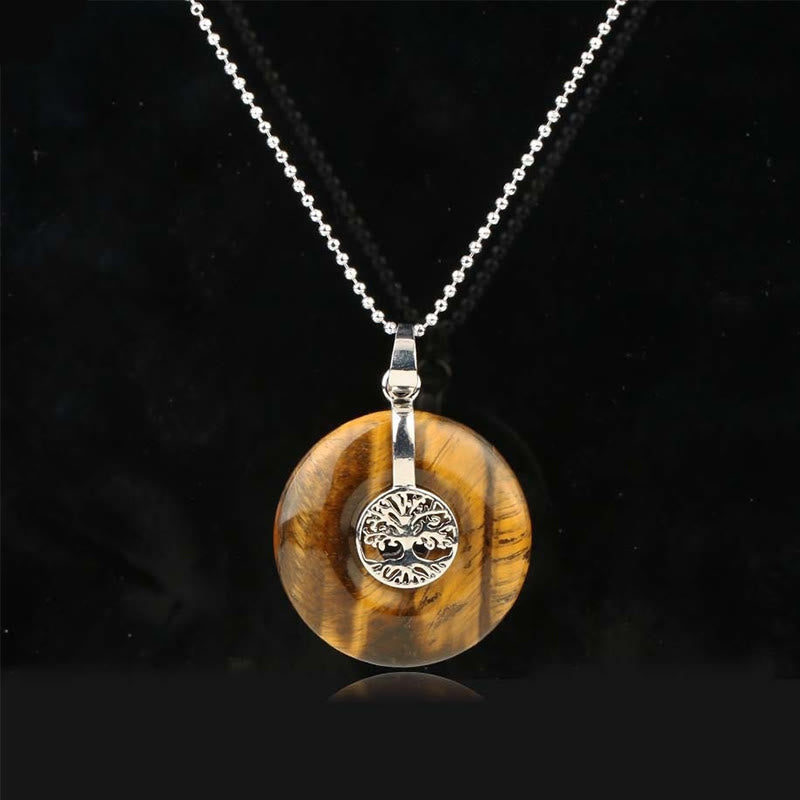 Tree of Life Crystal Necklace – tiger eye golden-brown donut pendant on black, frontal silver chain view