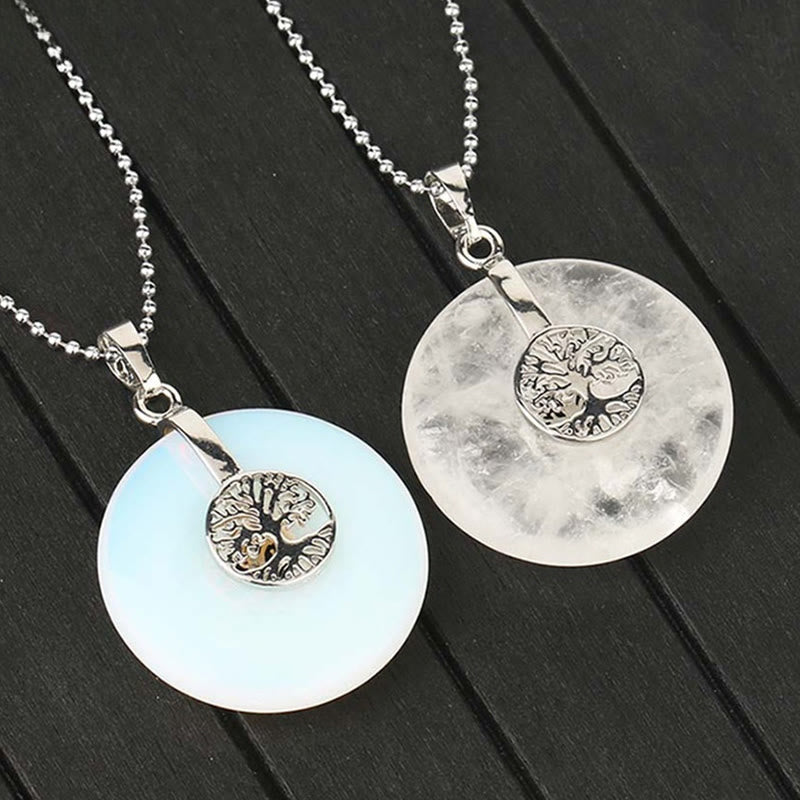 Tree of Life Crystal Necklace – opalite and clear quartz pendants on dark wood, elevated dual stone view