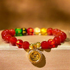 Red Agate Wealth Gods Bracelet – macro shot of rotating prayer wheel pendant with zircon halo, spiritual focus