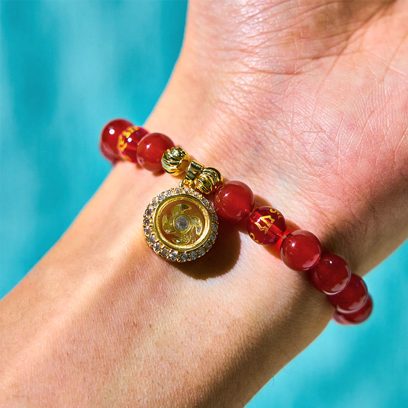 Red Agate Wealth Gods Bracelet – worn on wrist against turquoise backdrop showing pendant detail, daily wear