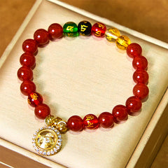 Red Agate Wealth Gods Bracelet – flat lay in satin jewelry box with crystal halo deity pendant, gift ready