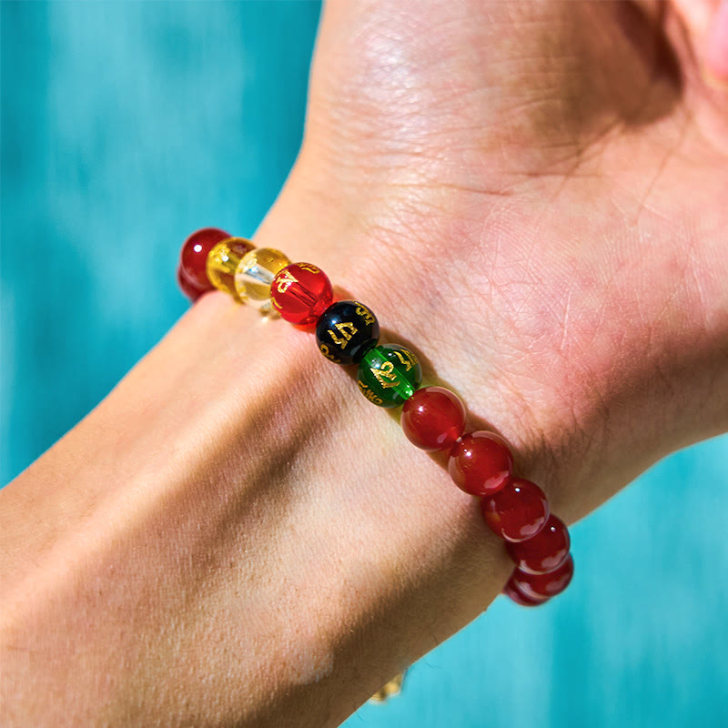 Red Agate Wealth Gods Bracelet – on wrist over cyan background displaying five direction beads, vitality