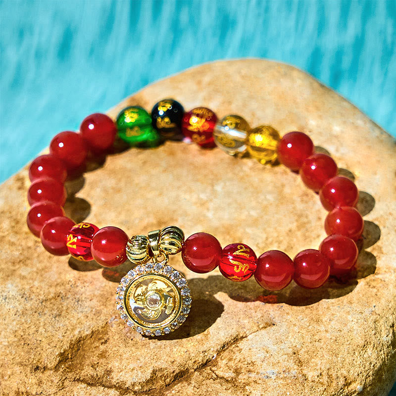 Red Agate Wealth Gods Bracelet – oval arrangement on stone showing five colored wealth god beads, abundance
