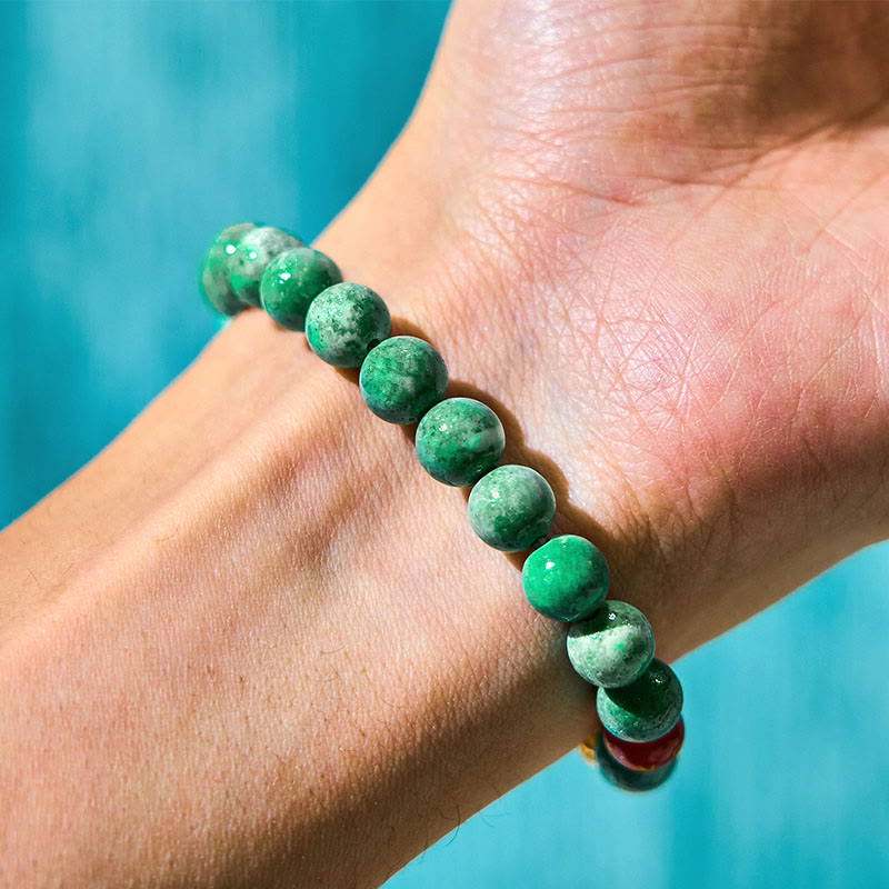 Natural Jade Om Mani Padme Hum Bracelet – Close-up on wrist showing marbled green jade bead texture