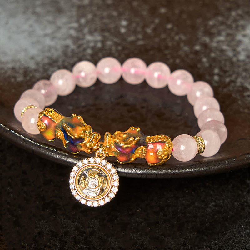 Pink crystal bracelet with double PiXiu on dark ceramic plate