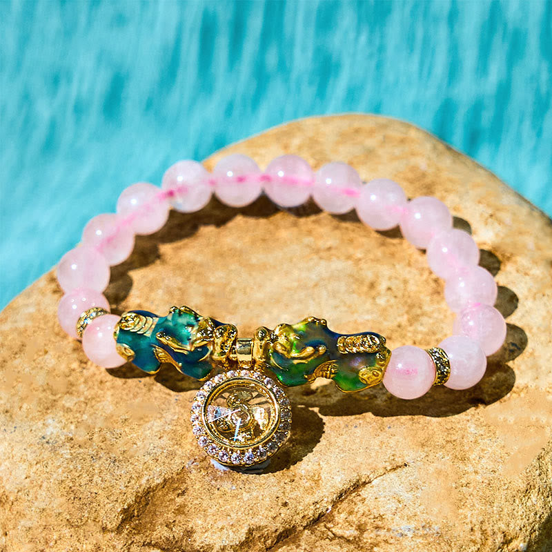 Pink crystal bracelet with double PiXiu on stone, side angle view