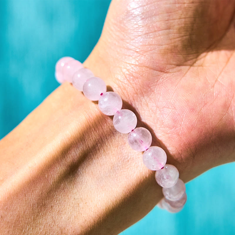 Close-up of pink crystal round beads on wrist in natural light