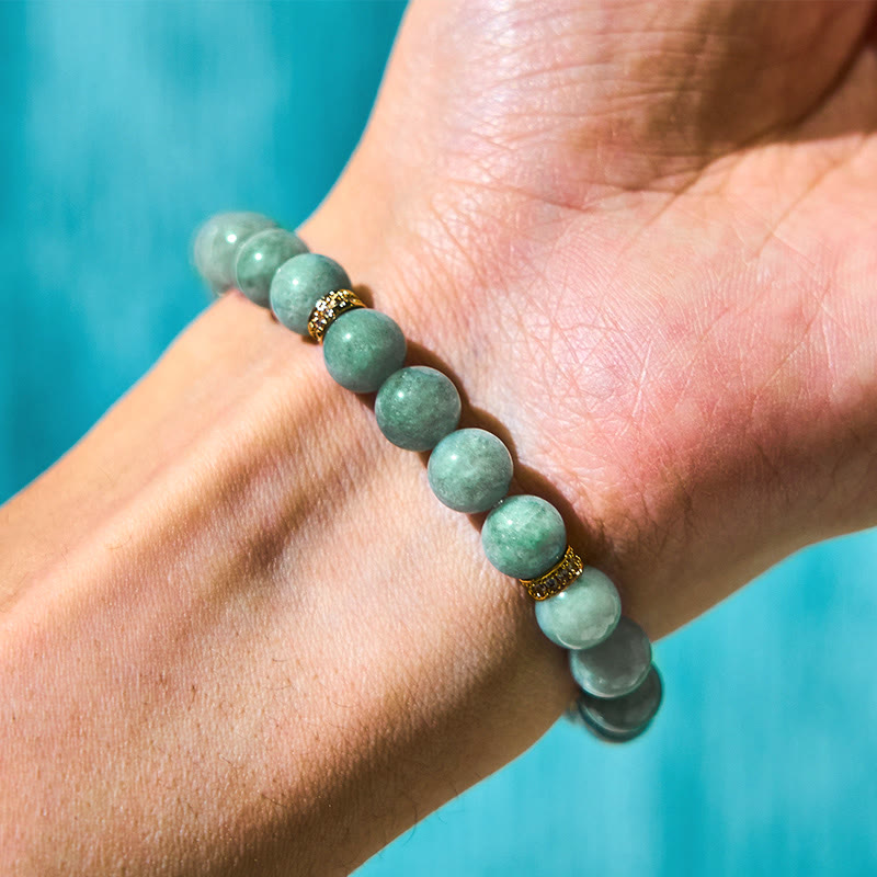 Green jade beaded bracelet on wrist, natural stone stretch bracelet