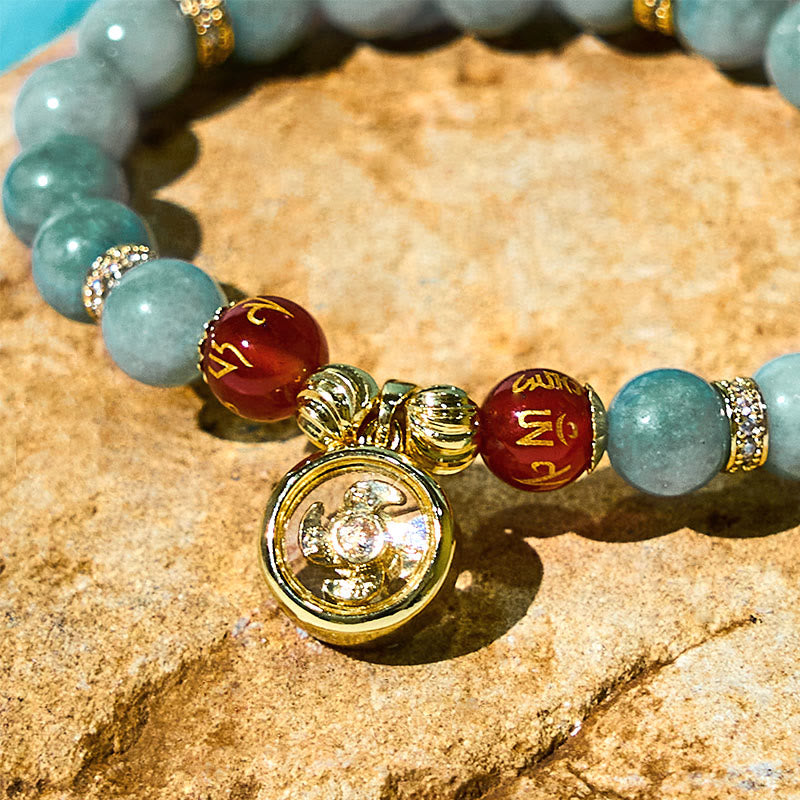 Green Jade Bracelet macro detail of gold Buddha pendant, mantra bracelet