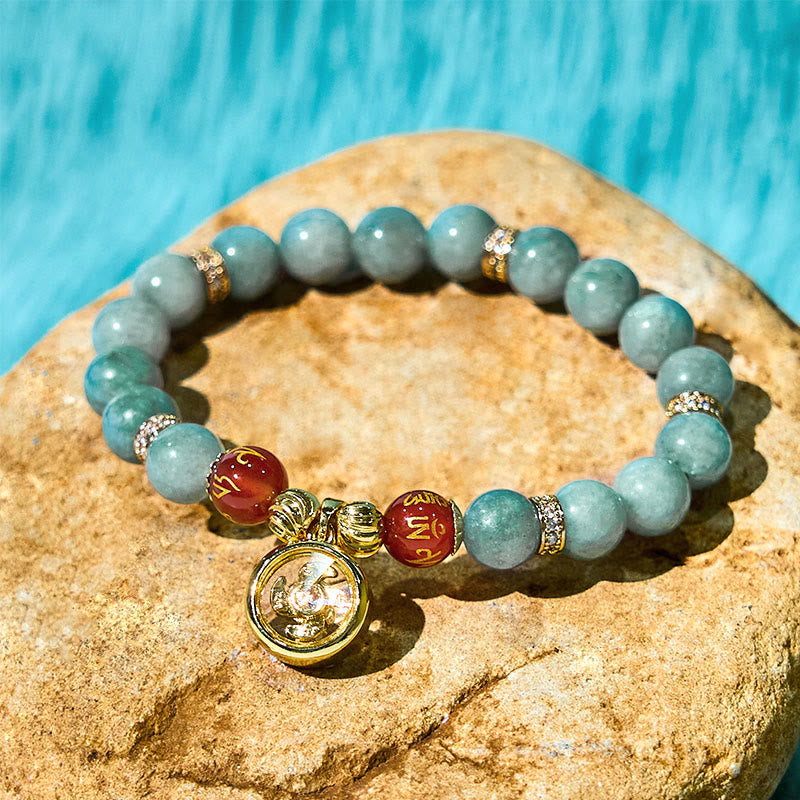 Green Jade Bracelet with horse charm on stone surface, spiritual jewelry