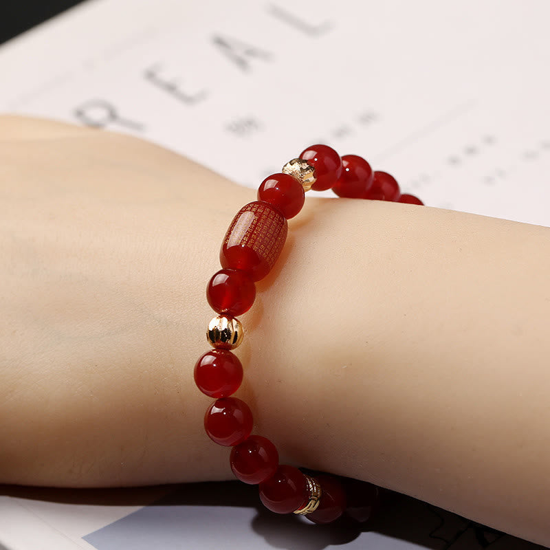 Red Green Agate Buddhist Sutras Calm Bracelet – worn on wrist side profile, etched barrel bead and gold accents close-up, pro