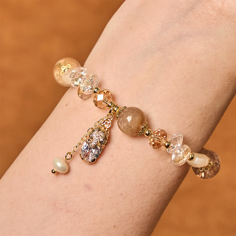 Citrine PiXiu Bracelet – Wrist shot of golden PiXiu charm with citrine and clear crystal beads, prosperity bracelet