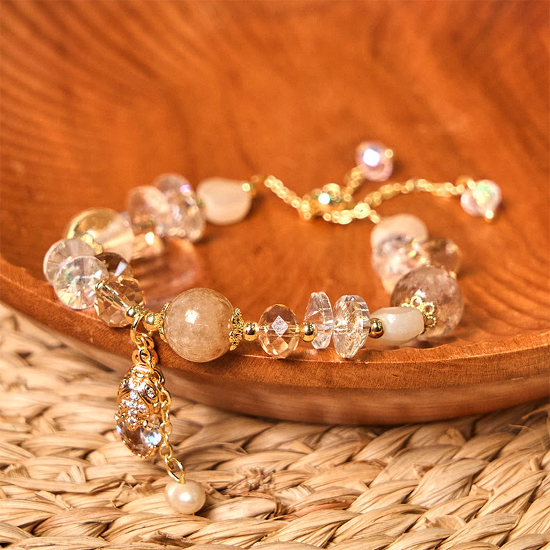 Citrine PiXiu Bracelet – Citrine and crystal beaded bracelet with golden PiXiu on wooden plate and woven mat