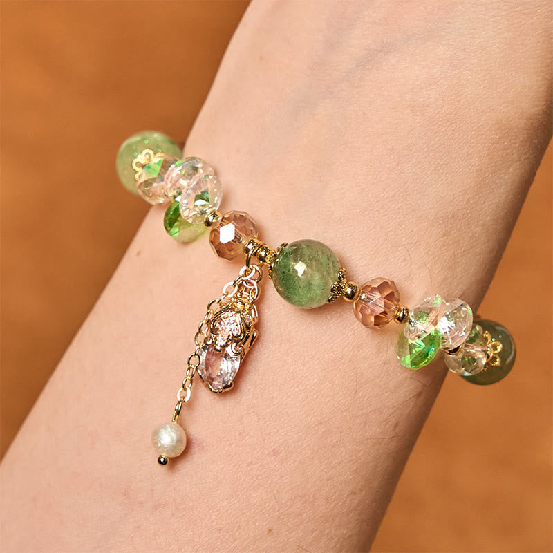 Green Strawberry Quartz Bracelet – Bracelet worn on wrist showing green quartz and golden PiXiu, prosperity jewelry