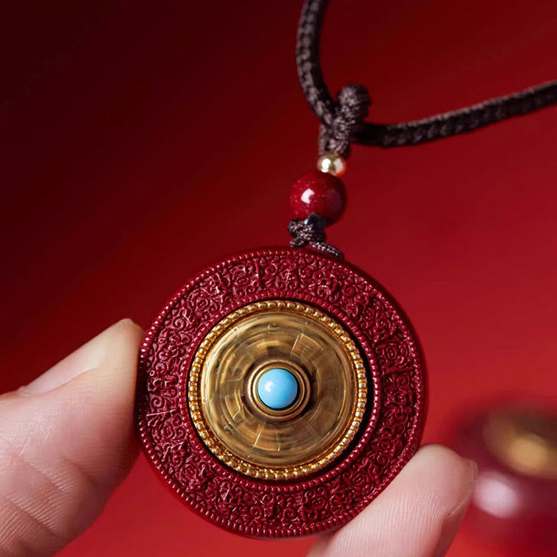 Cinnabar Scripture Pendant - Fingers reveal spinning gold disc with turquoise, auspicious