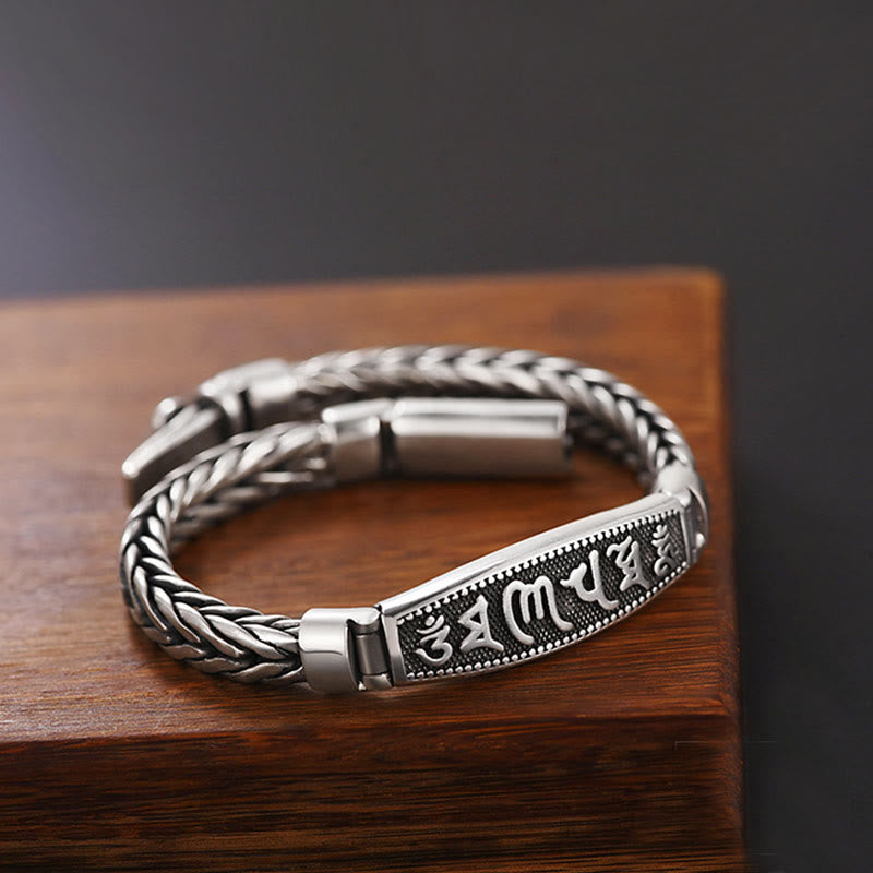 Vajra Om Mani Padme Hum Bracelet – Three-quarter view of braided chain with mantra engraving on wood, peace bracelet