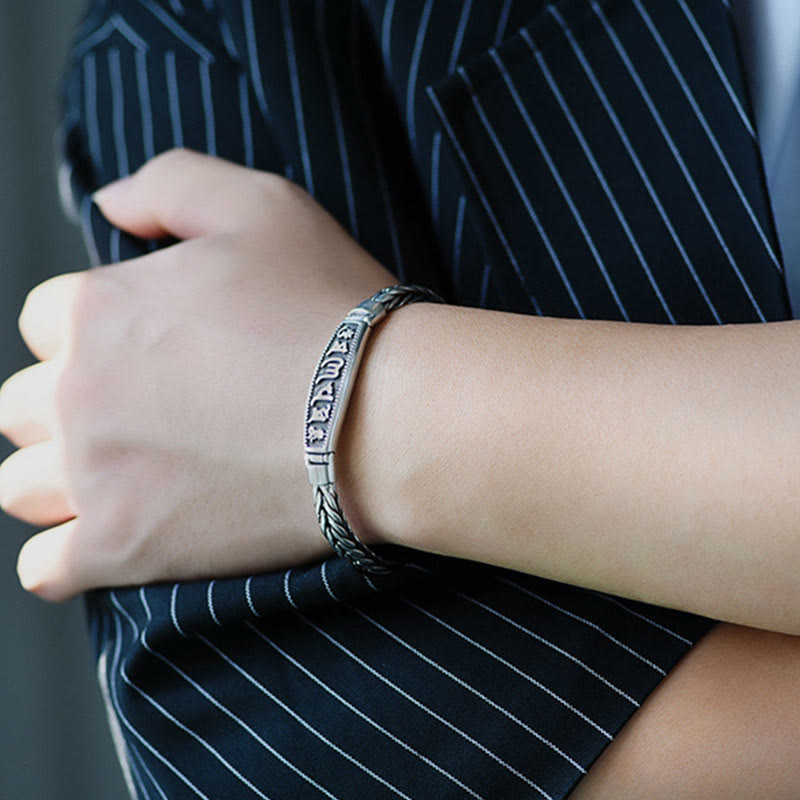 Vajra Om Mani Padme Hum Bracelet – Side view on wrist with formal attire, braided chain and mantra plaque