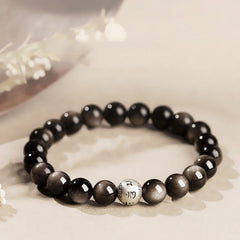 Silver Sheen Obsidian Bracelet – black beads with mantra bead on cream linen and dried botanicals, grounding protection