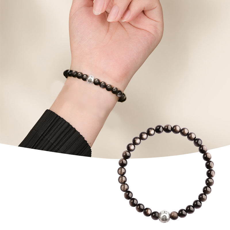 Silver Sheen Obsidian Bracelet – split view worn on wrist and laid on white, silver sheen shimmer, protective grounding