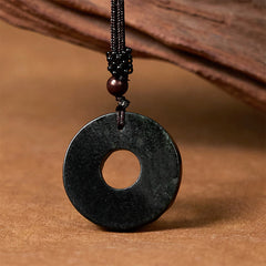 Back view of smooth polished black-green jade peace buckle pendant