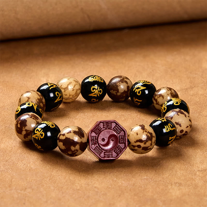 Bodhi Seed Bagua Yin Yang Bracelet – On parchment background with scroll detail, Taoist meditation beads
