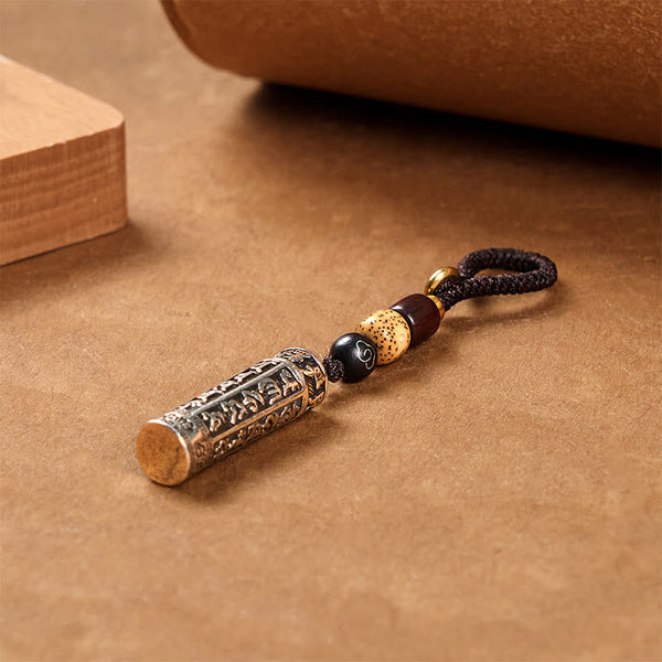 Tibetan Copper Vajra Key Chain – warm bronze patina cylinder with Bodhi seed bead three quarter view, strength