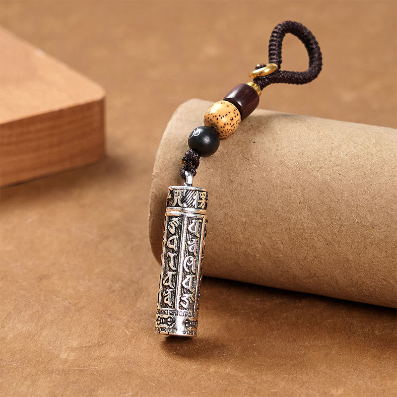 Tibetan Copper Vajra Key Chain – full piece on textured paper with kraft tube stand, artisan crafted