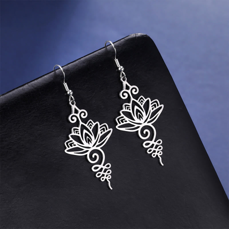Hollow Lotus Stainless Steel Enlightenment Drop Earrings - silver lotus dangles on black stand, blue gradient, mindful jewelry