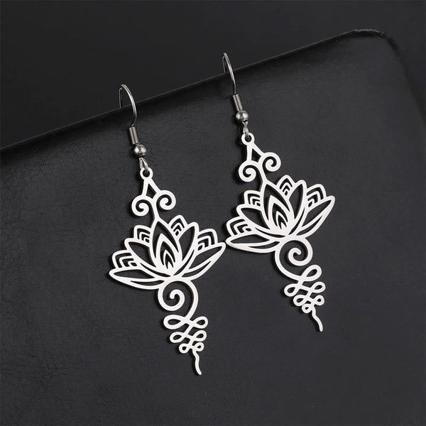 Hollow Lotus Stainless Steel Enlightenment Drop Earrings - silver openwork lotus with scrollwork, dark backdrop, zen style