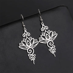 Hollow Lotus Stainless Steel Enlightenment Drop Earrings - silver openwork lotus with scrollwork, dark backdrop, zen style
