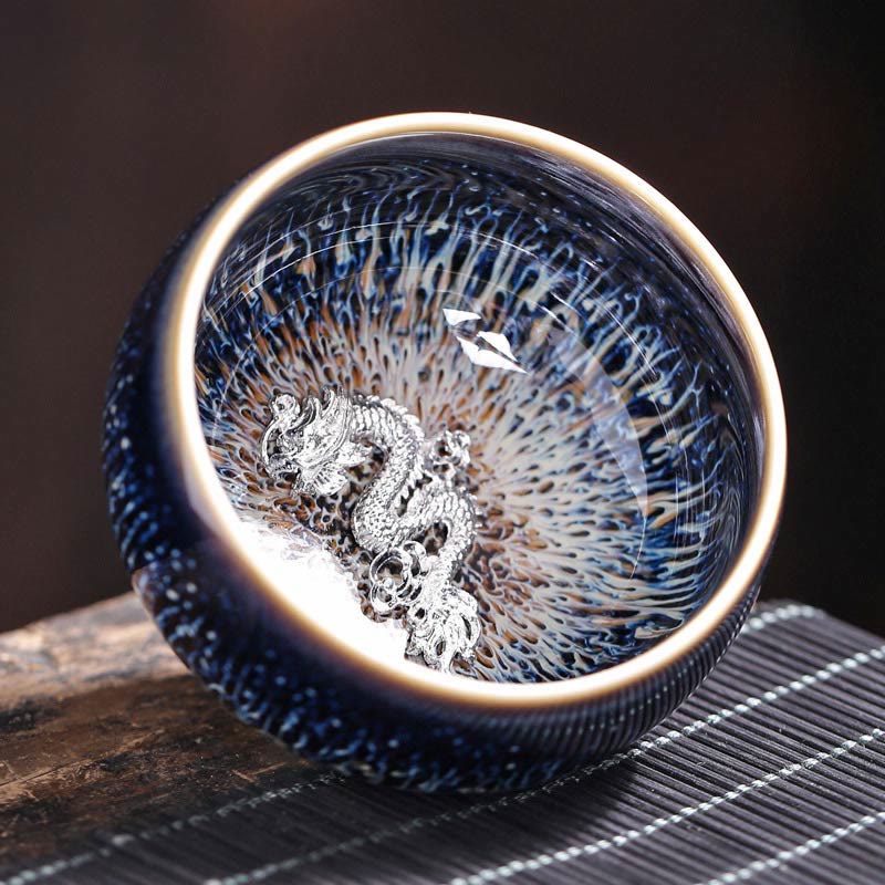 Jianzhan 12 Cup Set - cup with silver phoenix ornament, blue crystalline glaze, cream rim