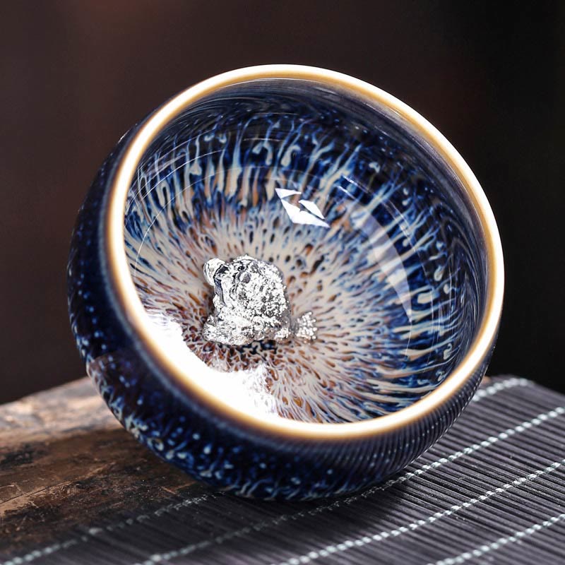 Jianzhan 12 Cup Set - several cups with zodiac silver ornaments in flat lay, tenmoku ware