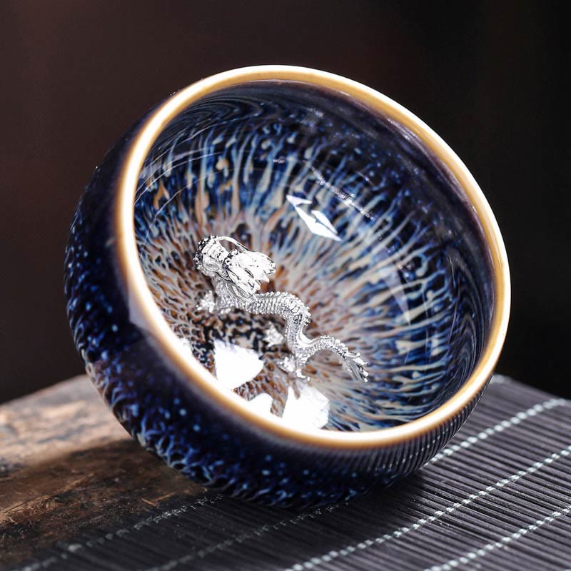 Jianzhan 12 Cup Set - cup with silver dragon inlay, blue oil-spot glaze on bamboo mat